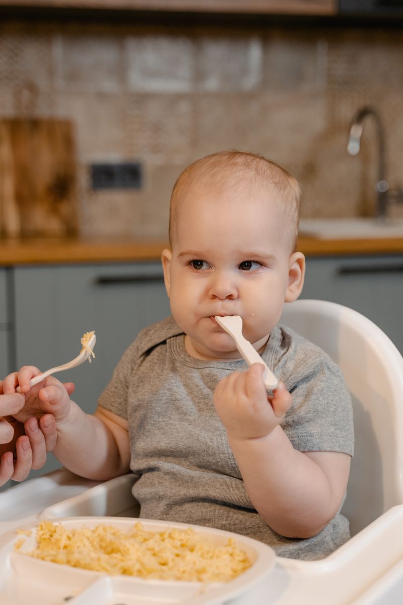 A baby being fed from a spoon at home