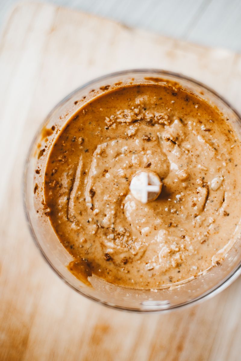 Warm nut butter being ground in the machine